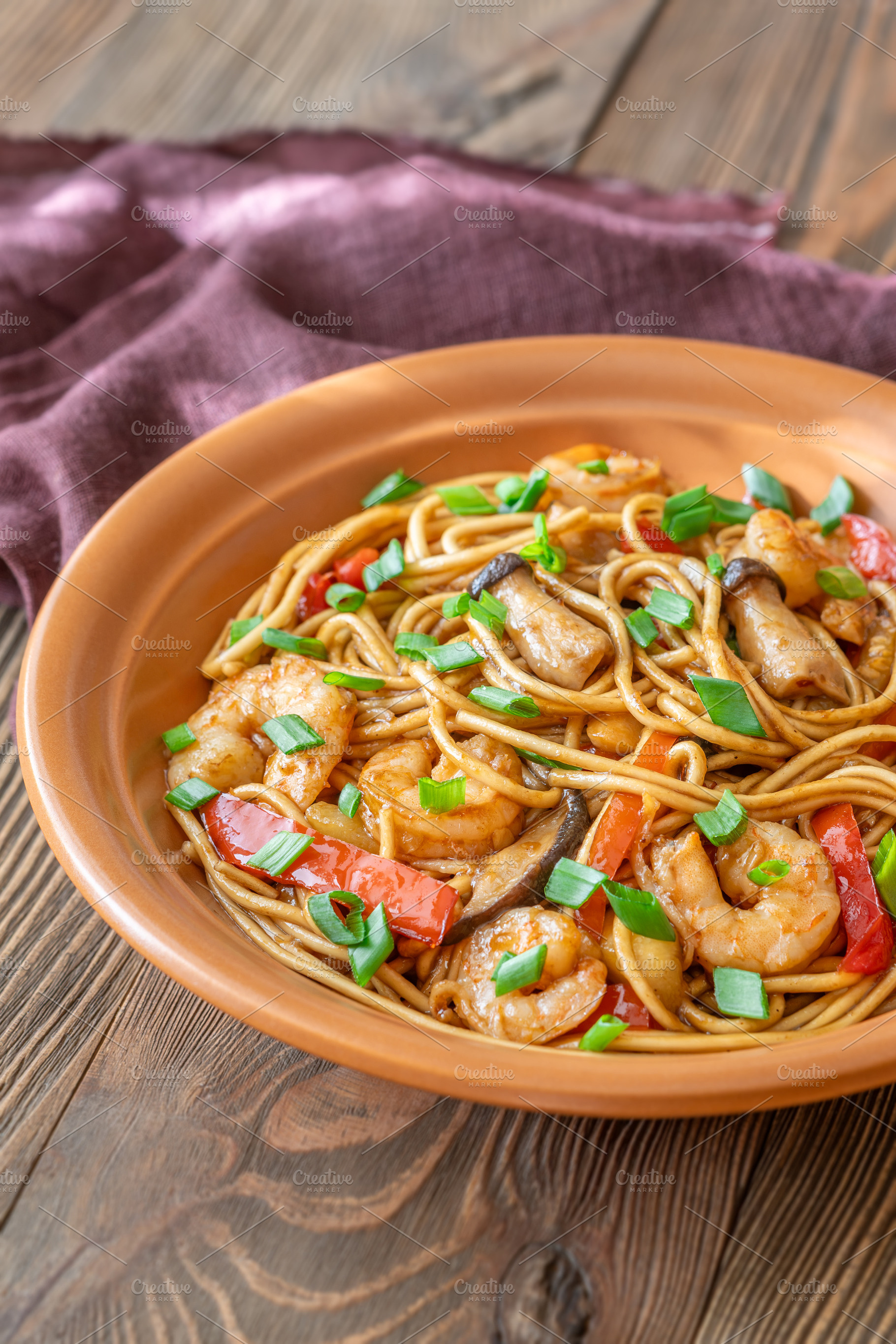 Asian stir fry udon noodles with prawns mushrooms vegetables in, a Food & Drink Photo by Alexander Prokopenko