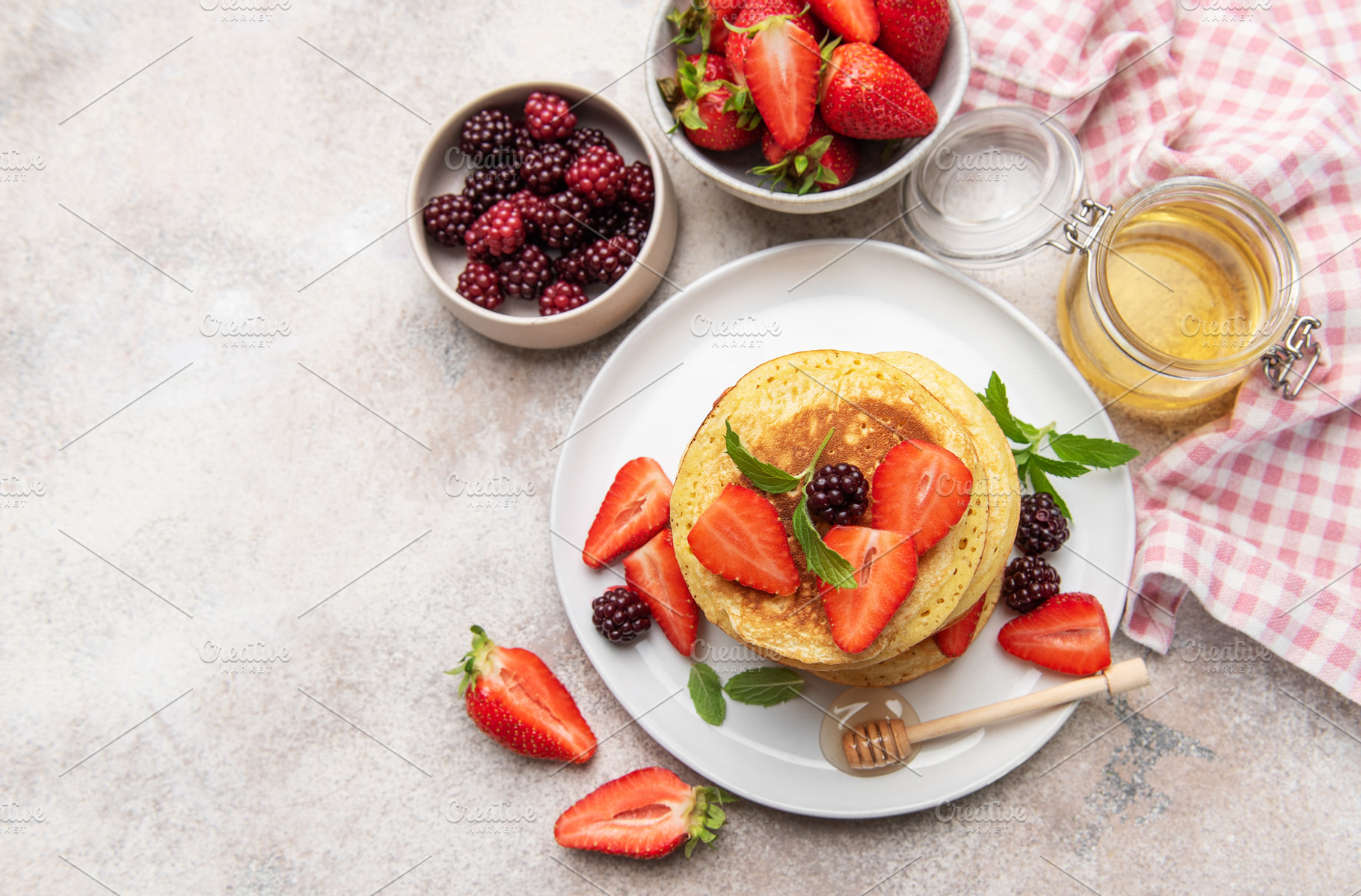 Stack of pancakes with fresh berries and honey for breakfast, a Food & Drink Photo by Olena Rudo
