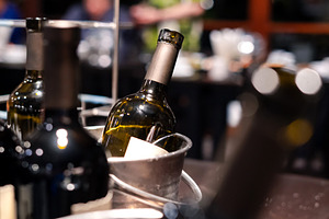 close-up of red wine bottle in ice bucket on romantic table, bac, a Health & Medical Photo by Casanowe-studio