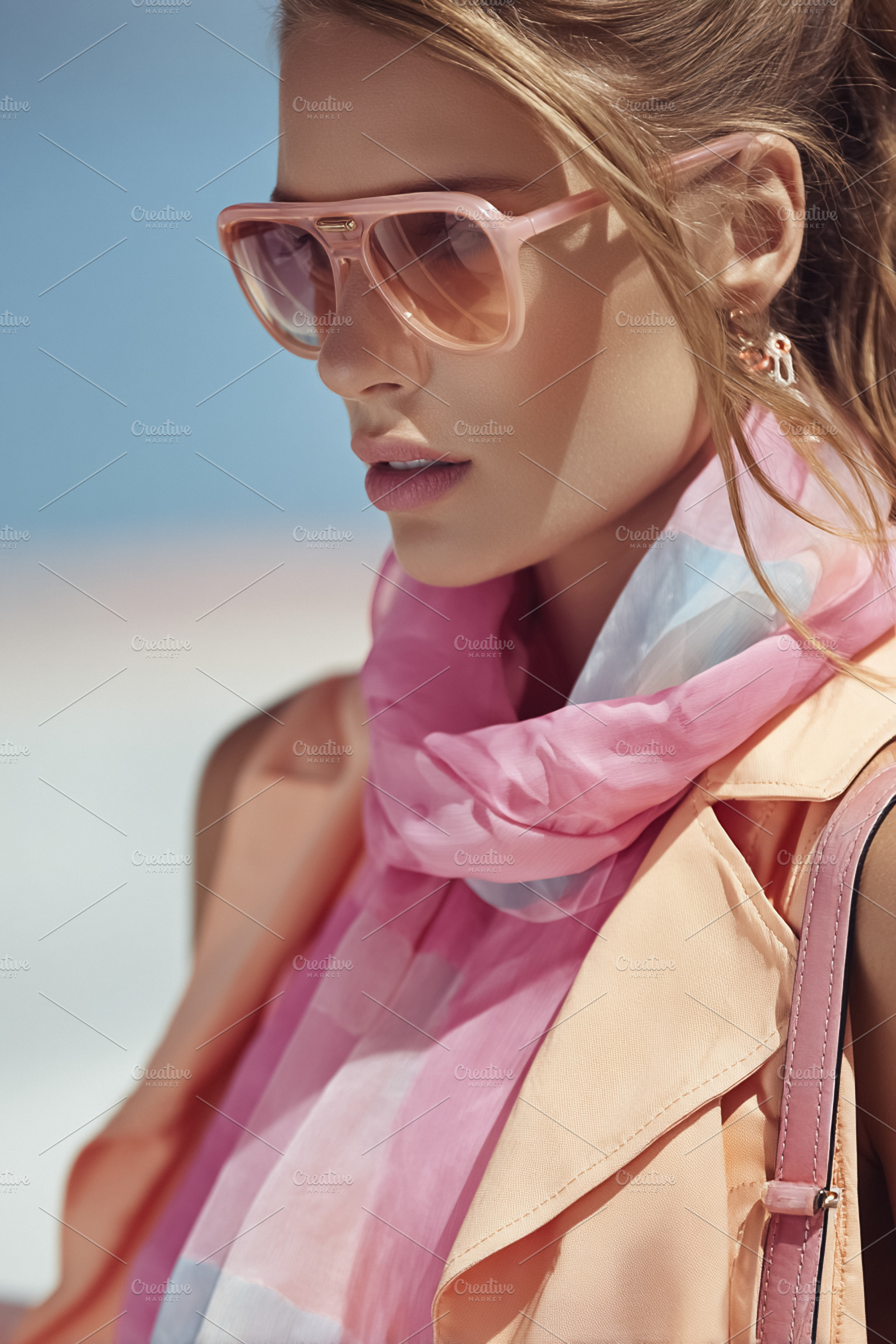 Woman wearing fashionable pink sunglasses and a light scarf, enj, a Beauty & Fashion Photo by Studio ANNA