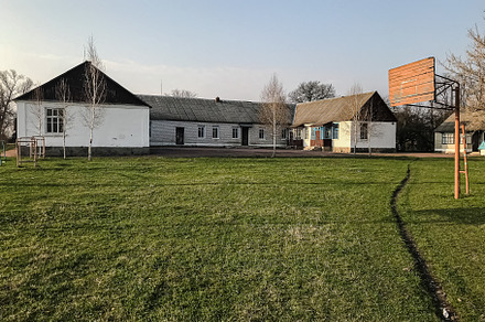 school building and old abandoned basketball court in the villag, an Architecture Photo by TanaCh
