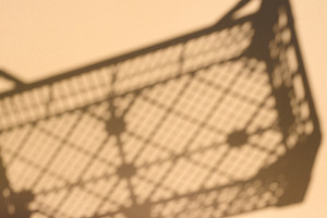 Sharp shadow of a plastic crate or lattice box on a light wall, an Abstract Photo by ndanko