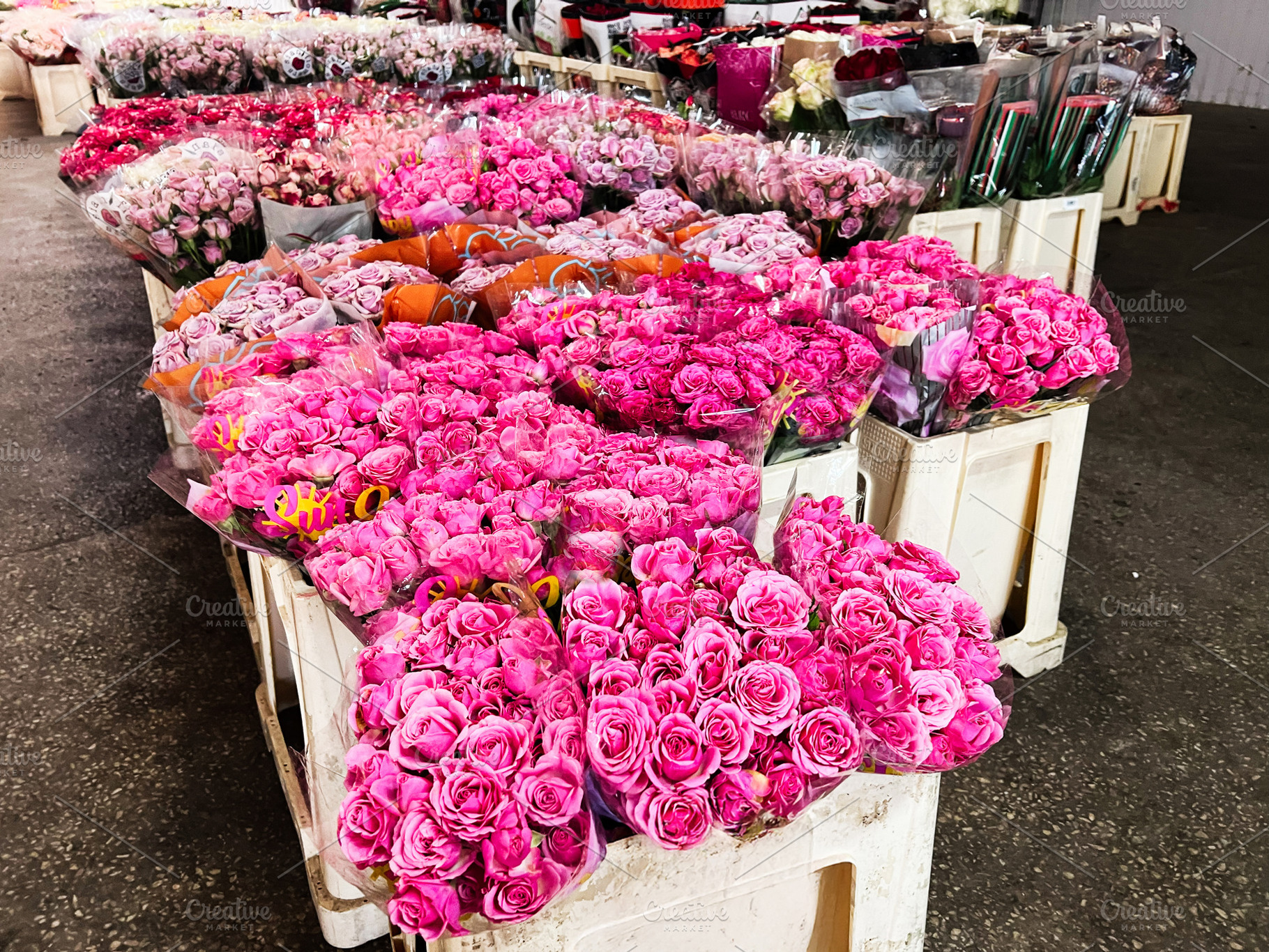 Abundant display of pink rose bouquets at a vibrant flower market, a Photo by AS photostudio
