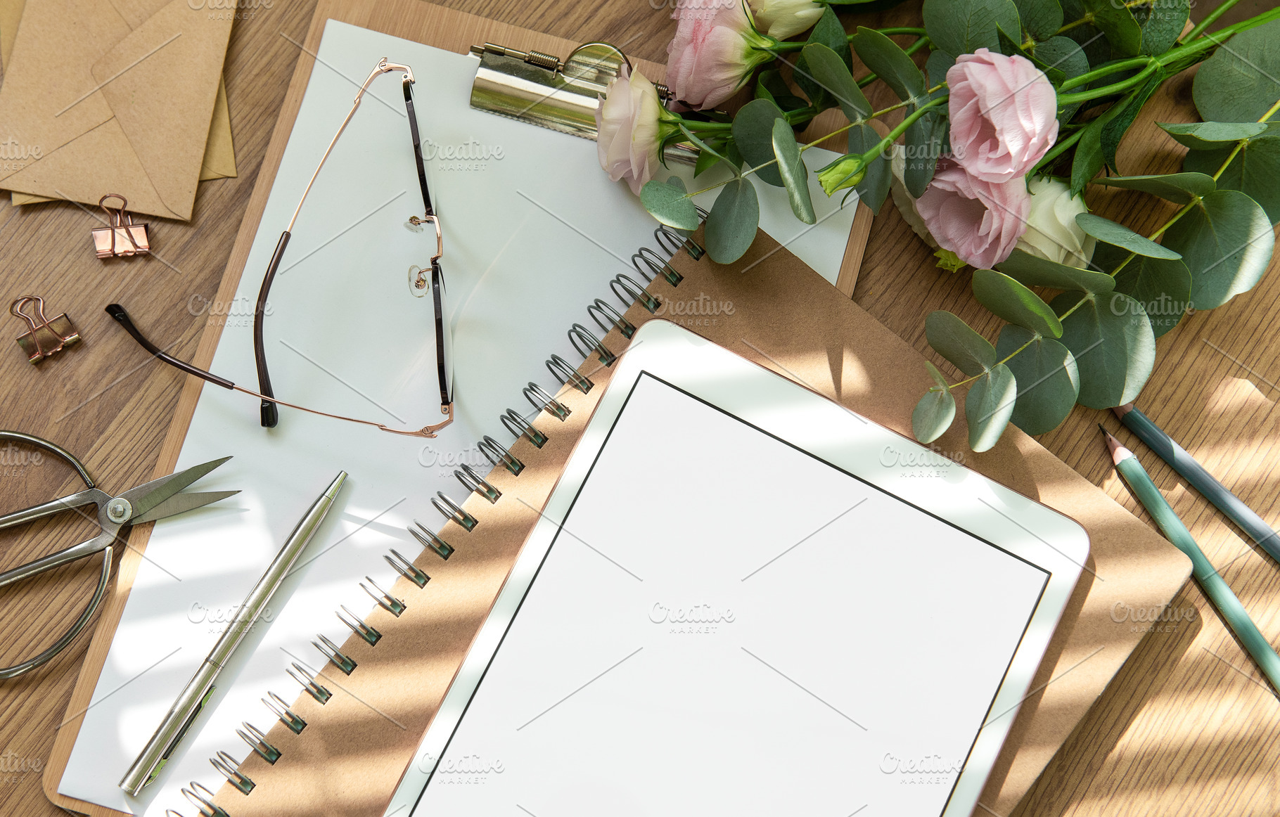 Stationery workspace with a blank tablet, notebook, and flowers, a School & Education Photo by Olena Rudo