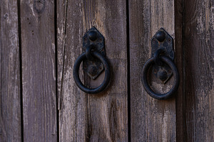 Metal handles on the old wooden door background, an Architecture Photo by Anna Bogush