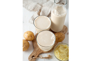 Potato milk pouring into glass on, a Food & Drink Photo by Fascinadora
