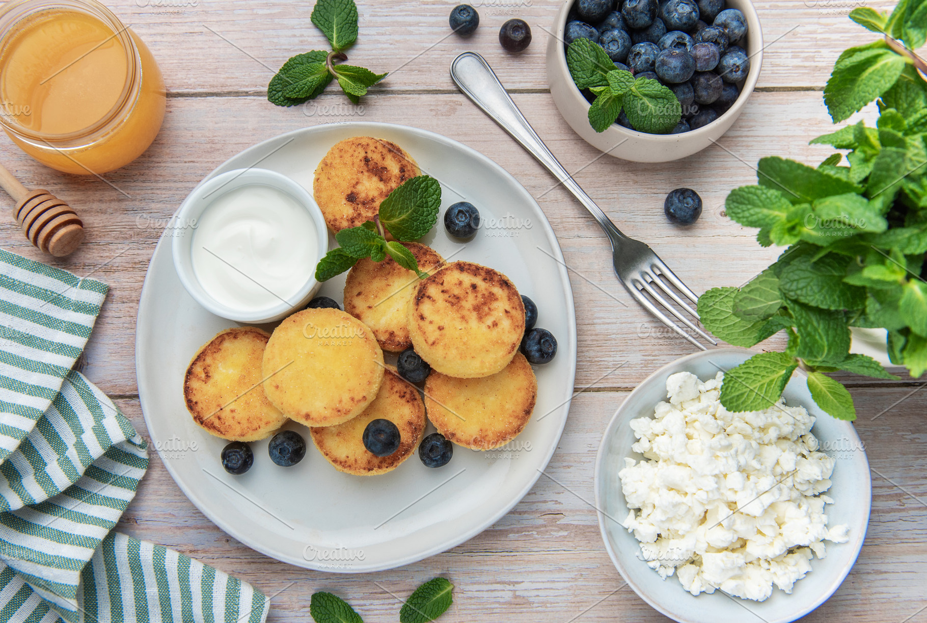 Syrniki cottage cheese pancakes with blueberries and mint, a Food & Drink Photo by Olena Rudo