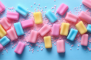 Colorful pastel candies scattered on, a Photo by Tanuart