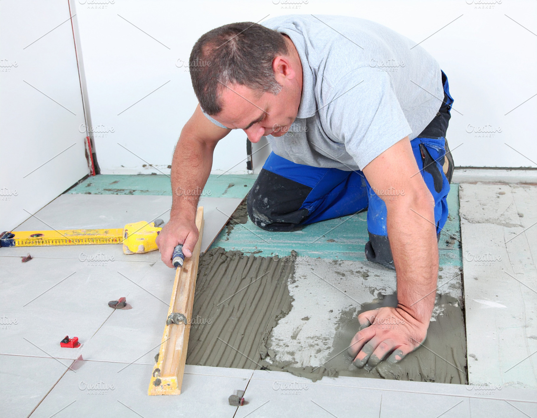 Man tile mason working inside a modern home, a Person Photo by DanFLCreativo