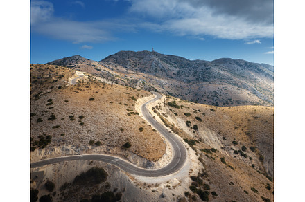 Aerial view of winding mountain road, a Transportation Photo by den-belitsky