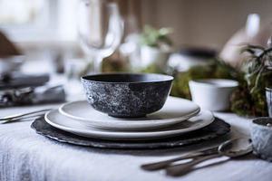 Dining table set with rustic stoneware dinnerware, featuring a d, a Photo by Studio ANNA