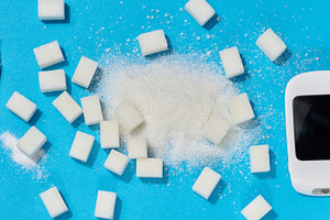 A glucometer, insulin syringe, and sugar cubes on a blue backgro, a Photo by ndanko