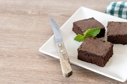 Chocolate brownie portions on wooden background, a Food & Drink Photo by etorres69