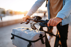 Close-up of cyclist at sunset by the waterfront, a Transportation Photo by AlyaAnd