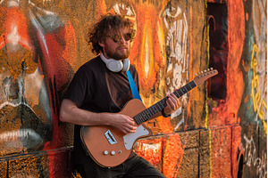 Street musician playing electric, a Person Photo by f9photos