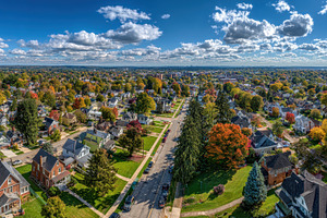 Aerial view of autumnal residential, a Photo by Pixeness Studio