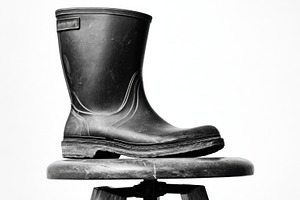 Black rubber boot on a stool, a Photo by Beautiful things