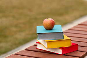 Single apple on stack of books place, a Wallpaper Photo by Elena Vagengeim