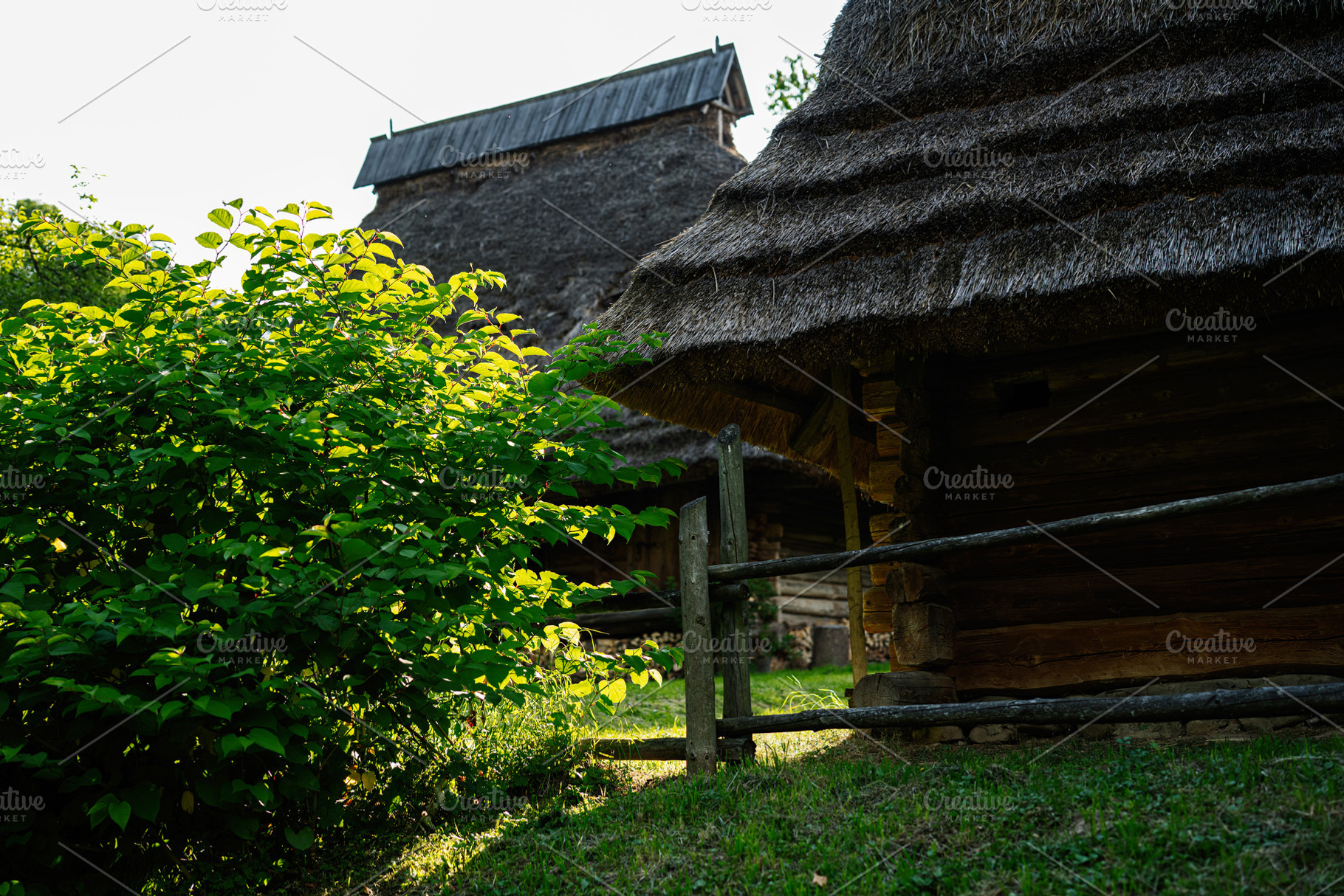 Rustic wooden cottages surrounded by lush greenery in a peaceful natural settin, a Photo by AS photostudio