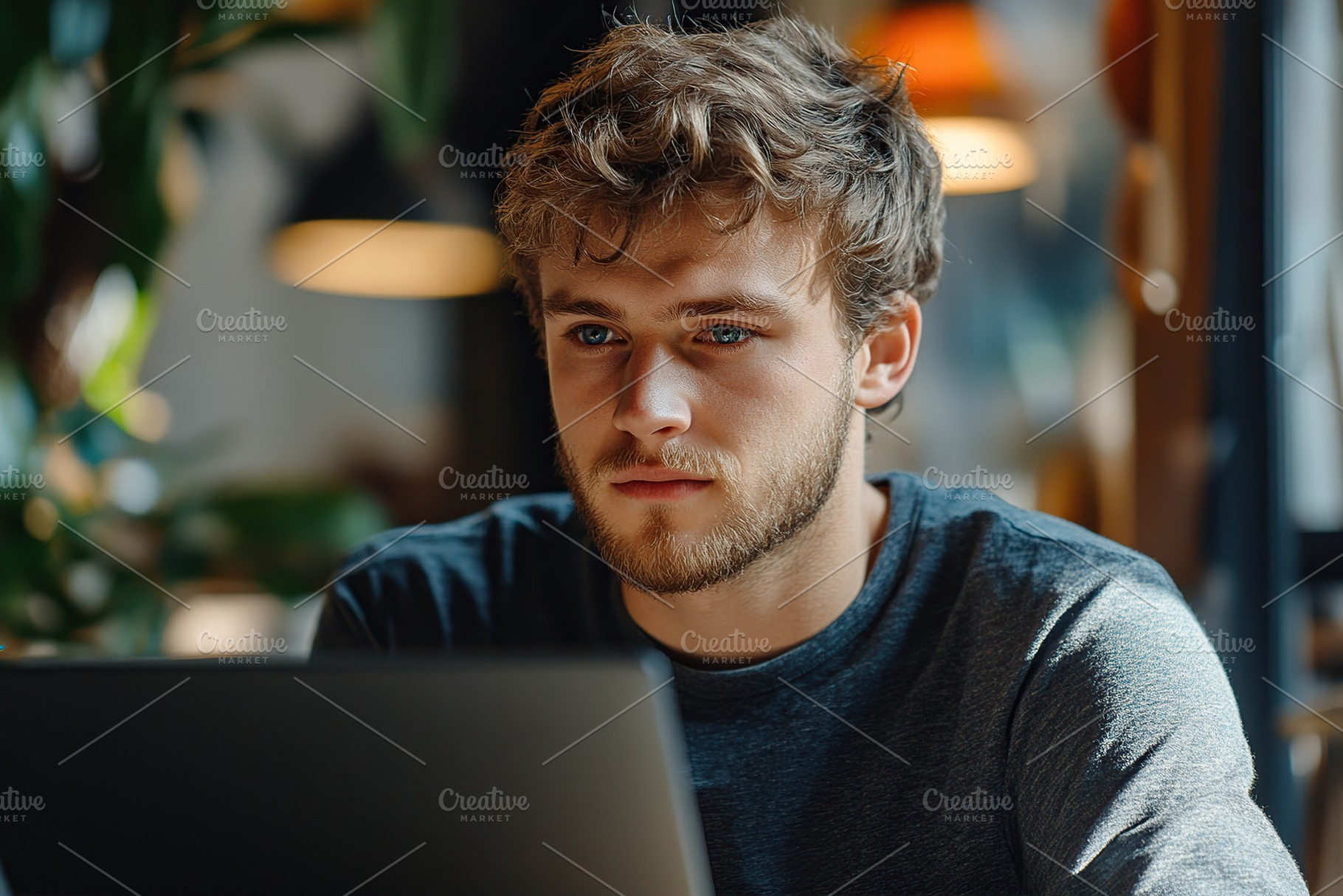 Employee engaged in focused work on laptop in a modern office space, a Person Photo by AlyaAnd
