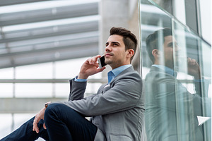 Young businessman making phone call, a Person Photo by HalfPoint