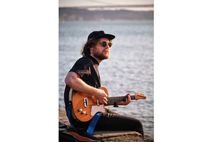 Street musician playing electric, a Person Photo by f9photos