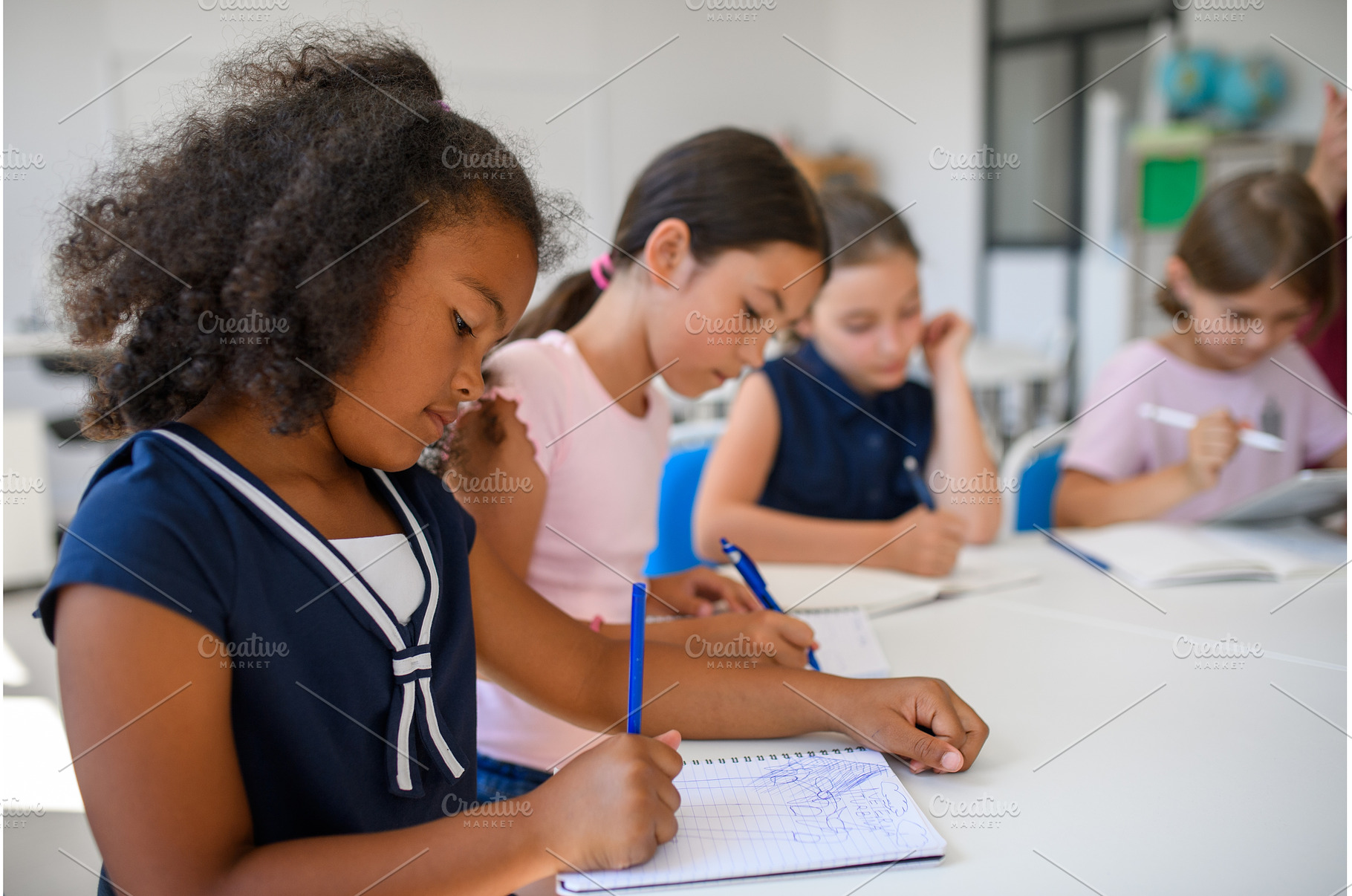 Schoolkids sitting at the desk in, a Person Photo by HalfPoint