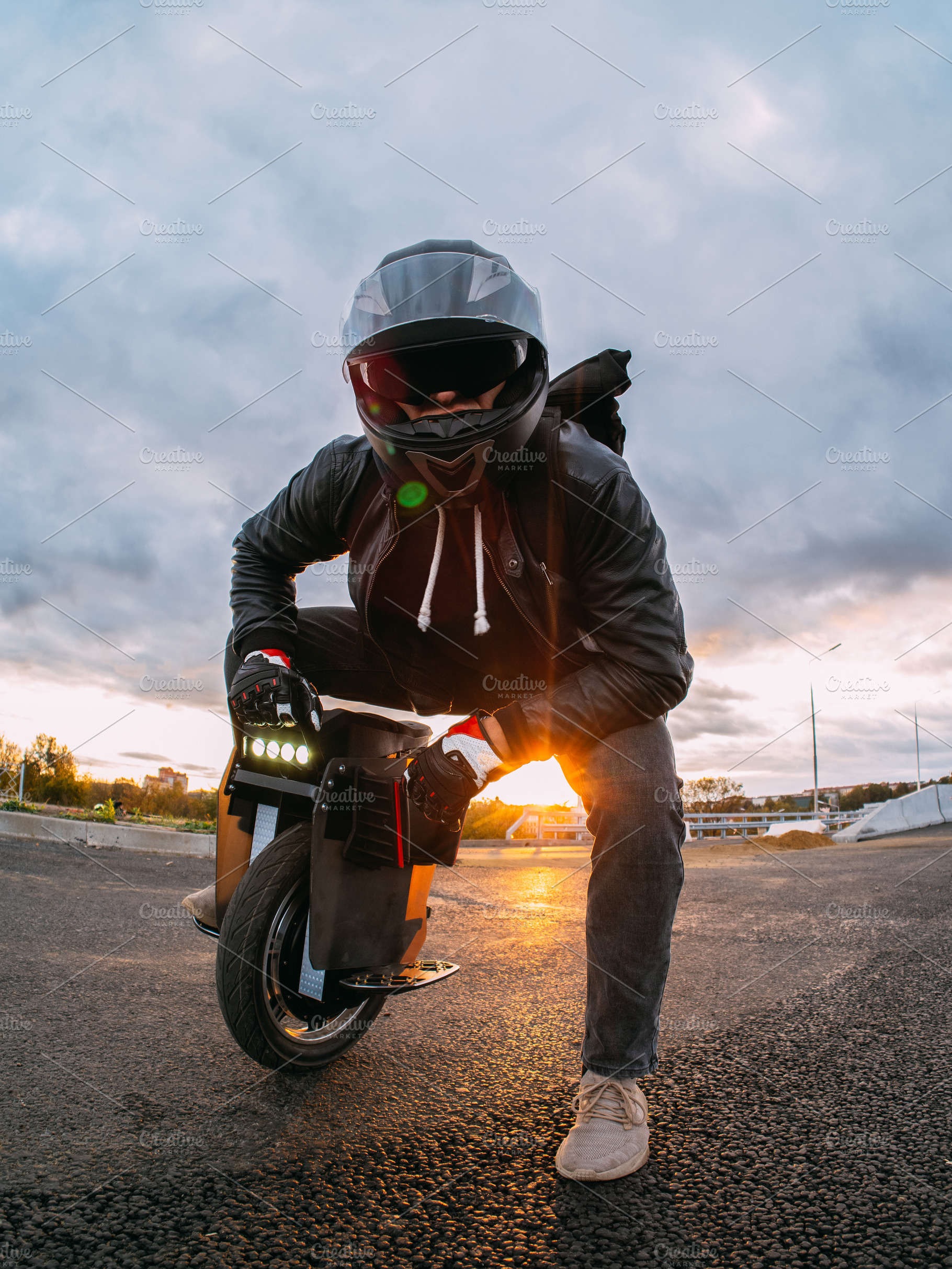 rider in a helmet with sunglasses rides on an electric mono whee, a Person Photo by PavelKant