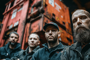 Team of workers posing in front of industrial machinery within a factory, an Industrial Photo by AS photostudio