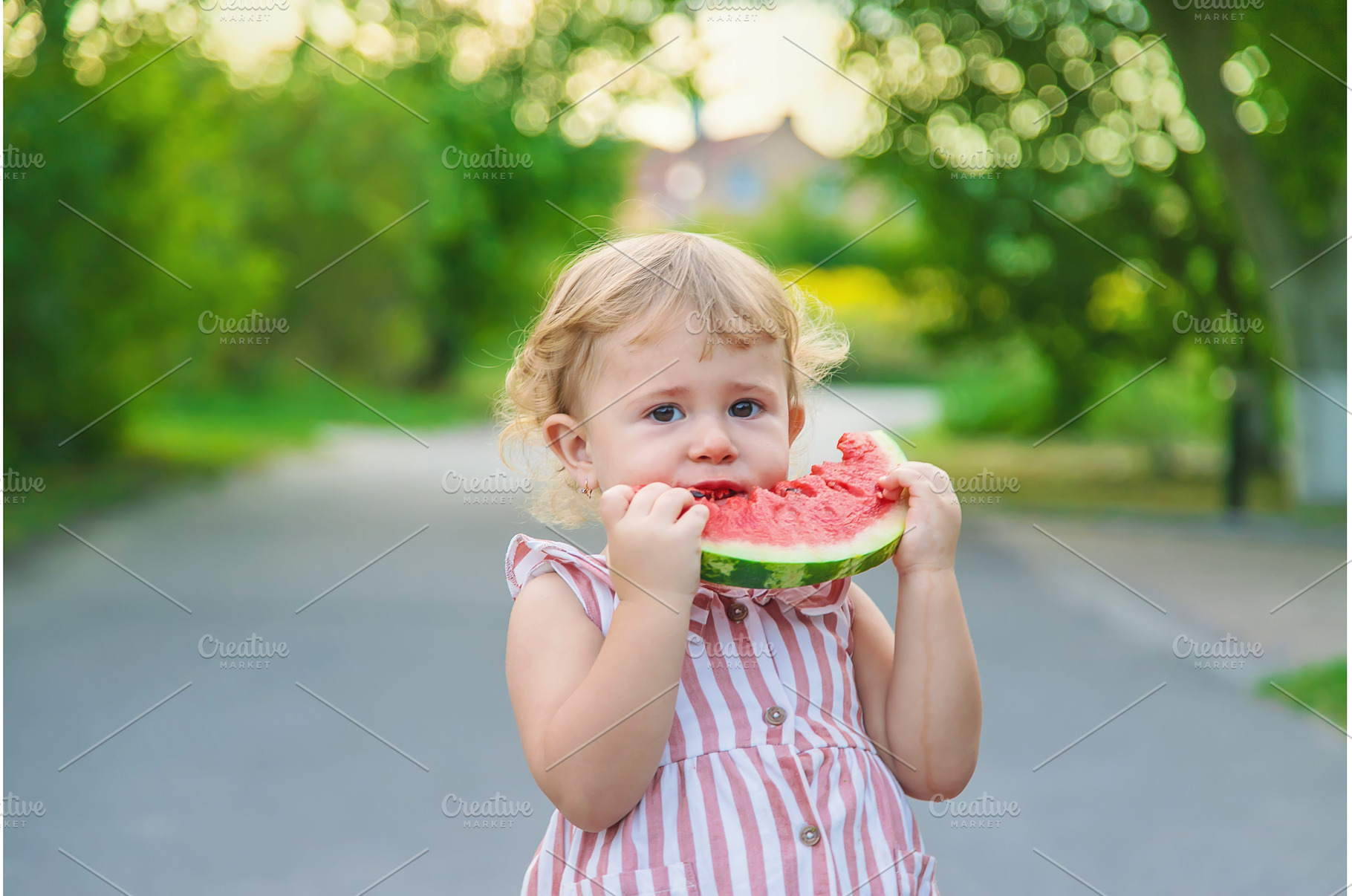 Child girl eats watermelon in summer, a Person Photo by yanadjana