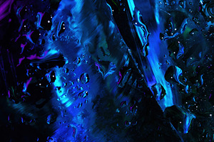 Abstract close-up of water droplets on a glass surface illuminat, a Background Photo by Ales Munt