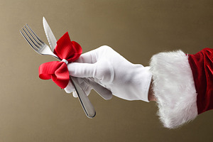 Christmas dinner with Santa's hand holding cutlery isolated brow, a Holiday Photo by Davizro's Market