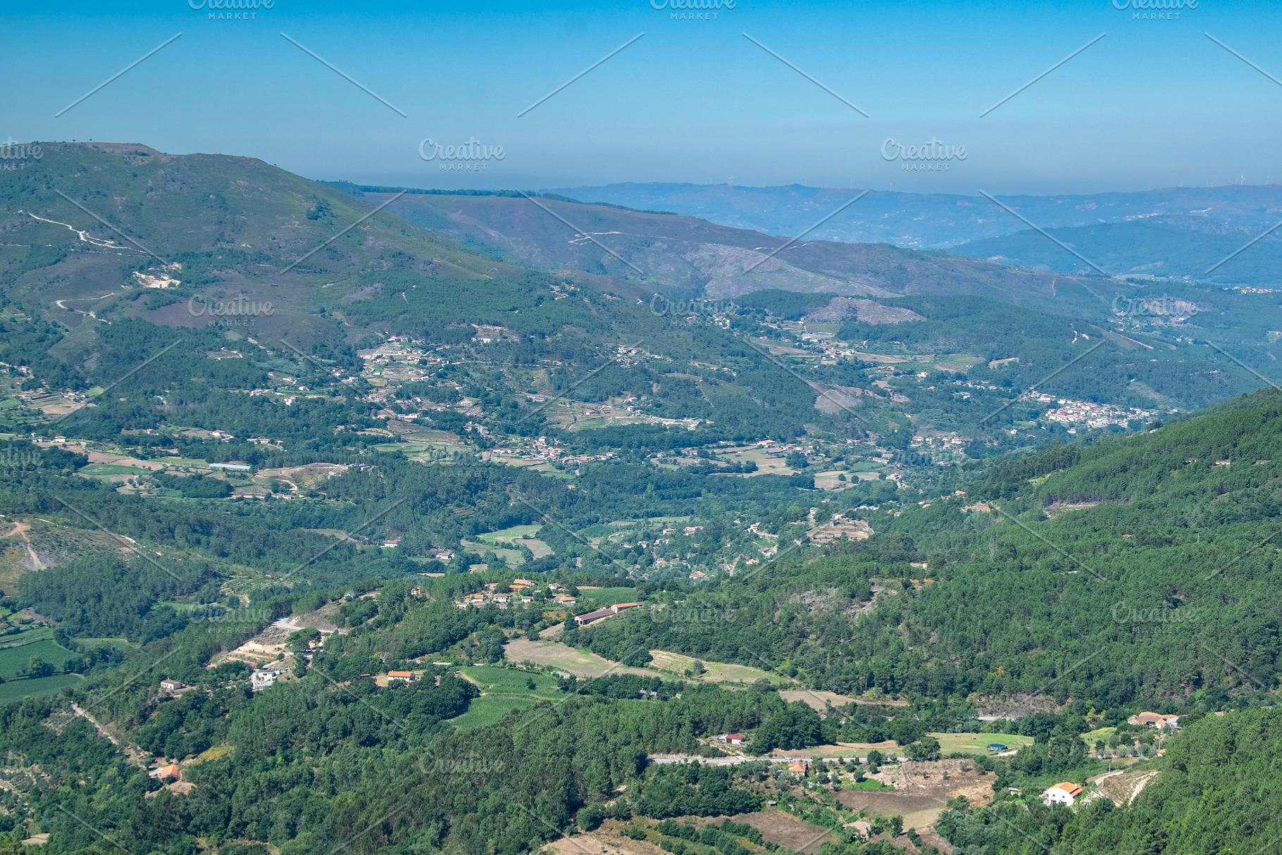 Mountain valley with forest and rural buildings, a Nature Photo by DanFLCreativo