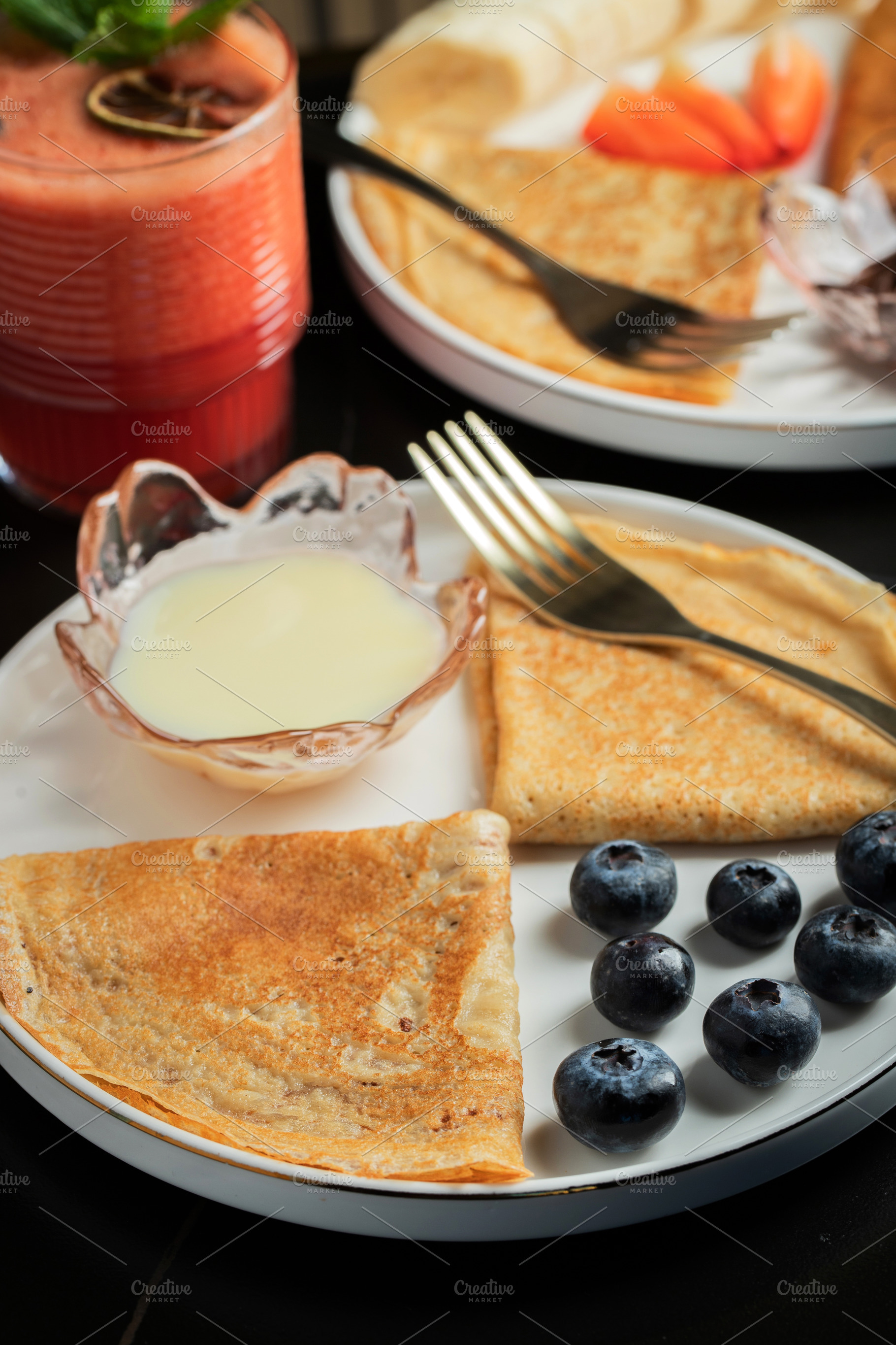 Pancakes with blueberry and honey on a white plate, a Food & Drink Photo by Budarinphoto