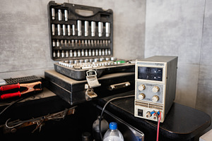 Closeup of tools and equipment on a workspace table in a workshop, a Photo by AS photostudio