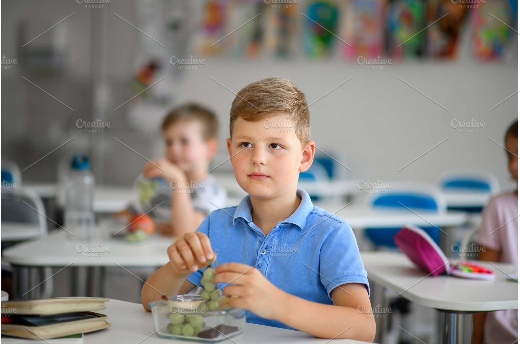 Children in the classroom eating a, a Food & Drink Photo by HalfPoint
