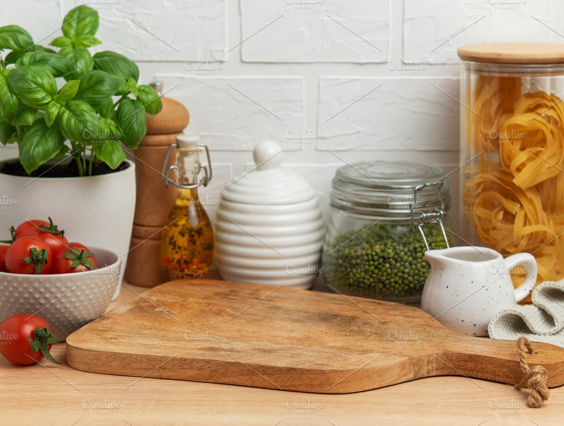 Empty wooden cutting board with various ingredients and utensils, a Food & Drink Photo by Olena Rudo