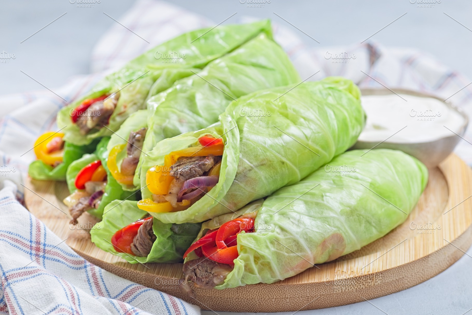 Cabbage leaves wraps with beef, vegetables and cheese, served with plain yogurt, a Food & Drink Photo by iuliia_n