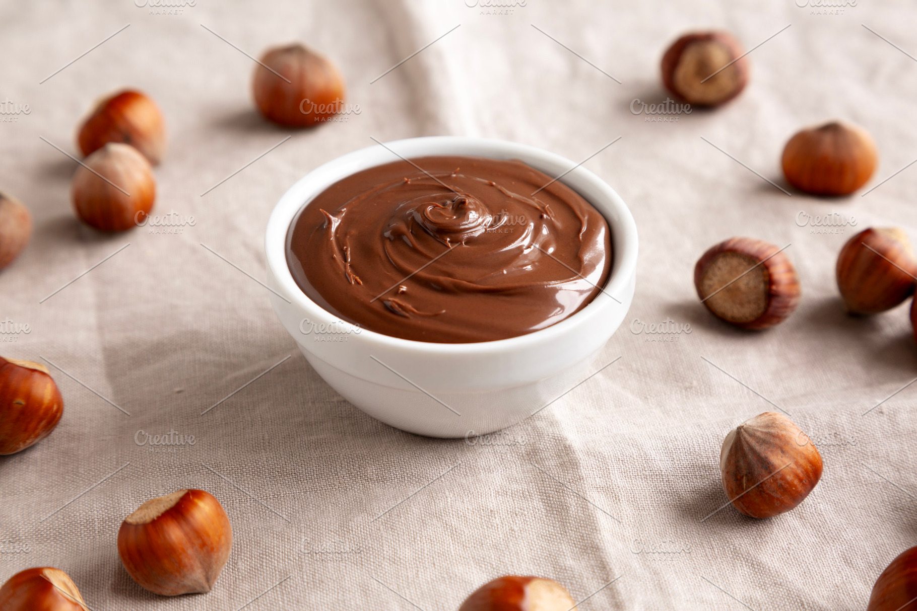 Homemade Chocolate Hazelnut Spread in a Bowl, side view. Close-u, a Food & Drink Photo by LiudmylaChuhunova