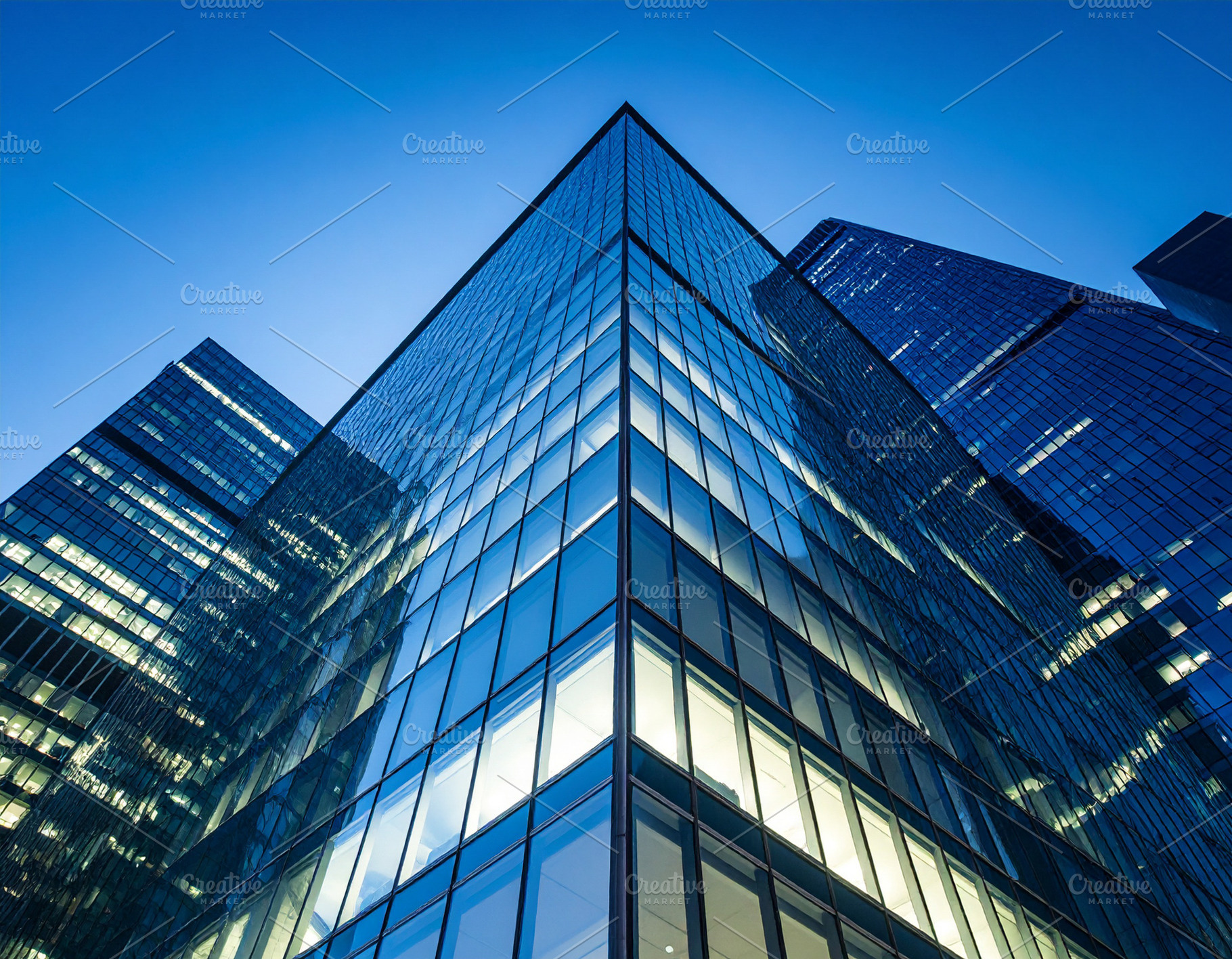 Illuminated skyscraper facade at dusk, isolated against a deep b, an Architecture Photo by DanFLCreativo