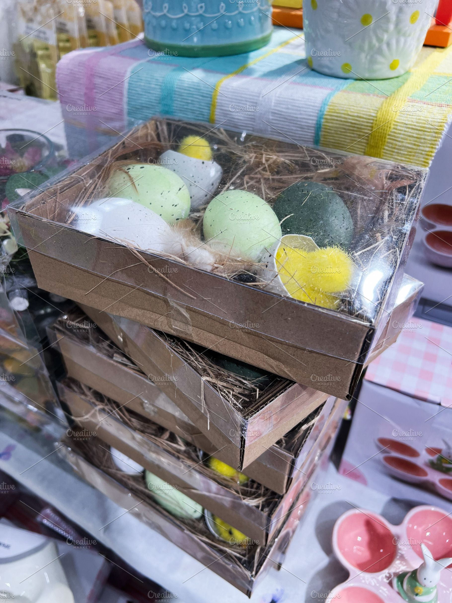 Decorative Easter eggs in packaging placed on a festive display table, a Photo by AS photostudio