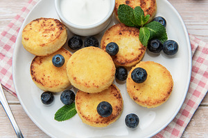 Syrniki cottage cheese pancakes with blueberries honey and sour, a Food & Drink Photo by Olena Rudo
