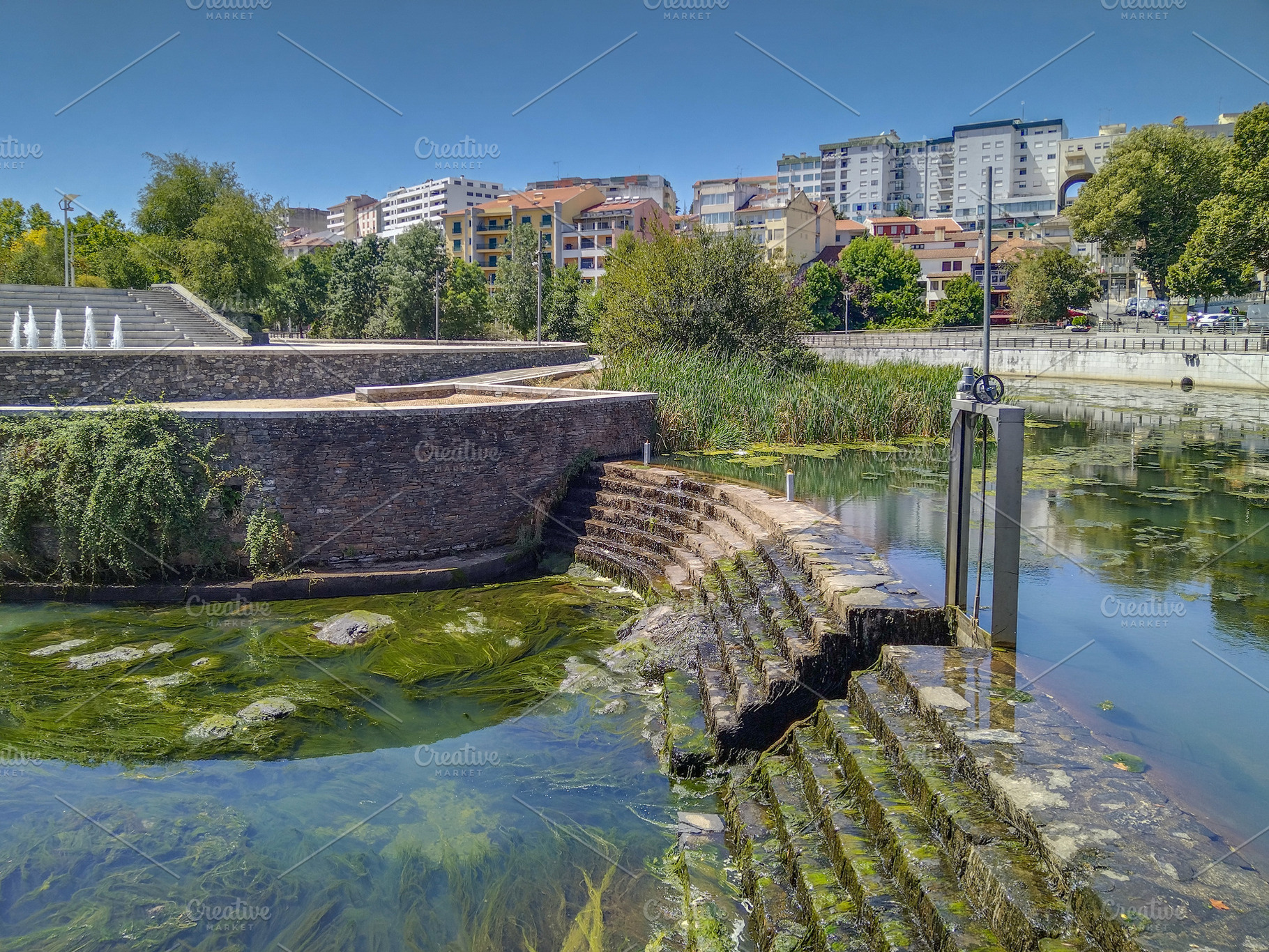 Urban river edge with moss and stair access, an Architecture Photo by DanFLCreativo