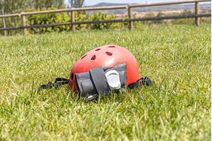 A red helmet and A gray wrist guard