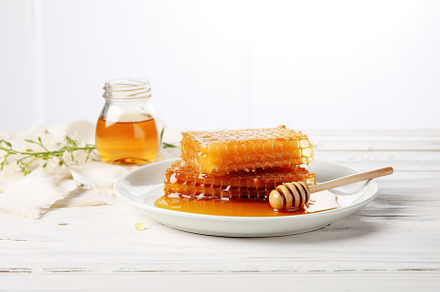 Honeycomb with honey and honey dipper on wooden background, a Food & Drink Photo by AlyaAnd