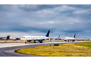 Airplanes lined up for takeoff at stock photo containing airplane and travel, a Transportation Photo by Leonid Andronov
