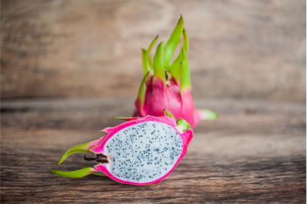 Healthy dragon fruits on old wooden, a Food & Drink Photo by Elizaveta Galitskaya