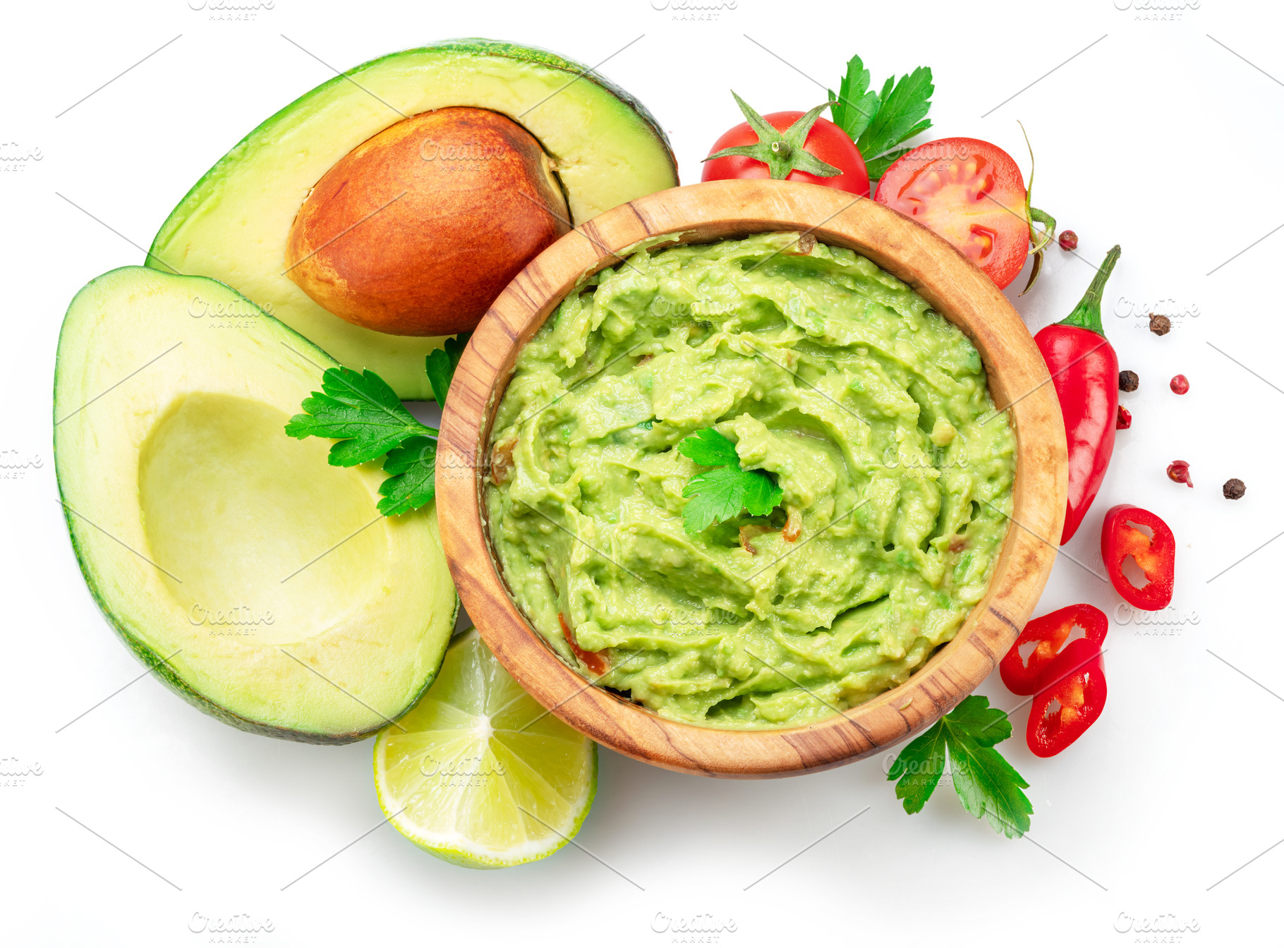 Guacamole bowl and guacamole ingredients isolated on white backg, a Food & Drink Photo by Volff