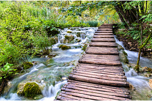 Wooden pathway above water at featuring croatia, plitvice, and waterfall, a Nature Photo by Leonid Andronov
