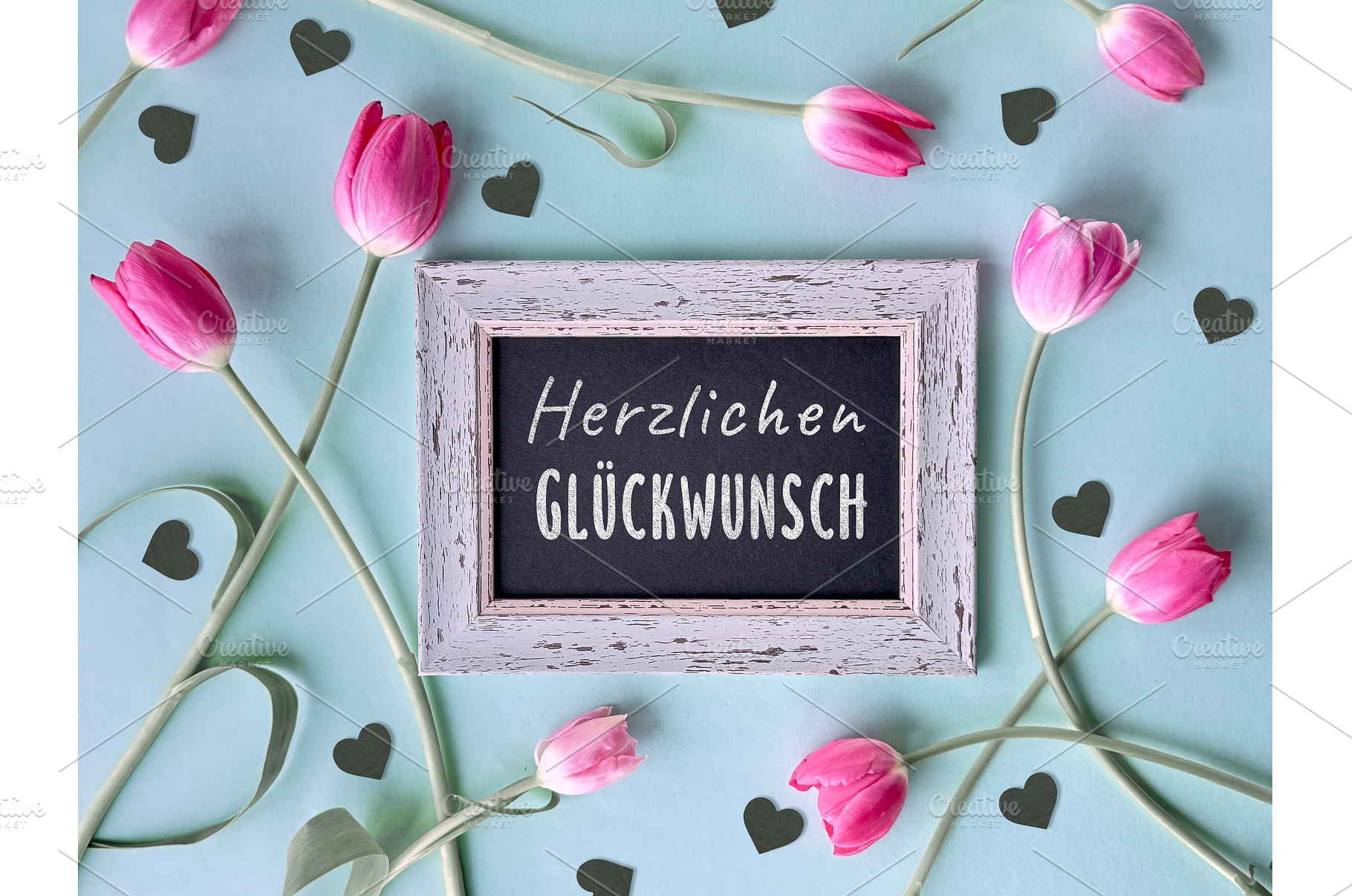 Pink tulips and black hearts around, a Photo by tilialucida